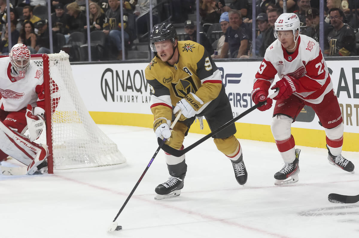 Golden Knights center Jack Eichel (9) skates with the puck under pressure from Detroit Red Wing ...