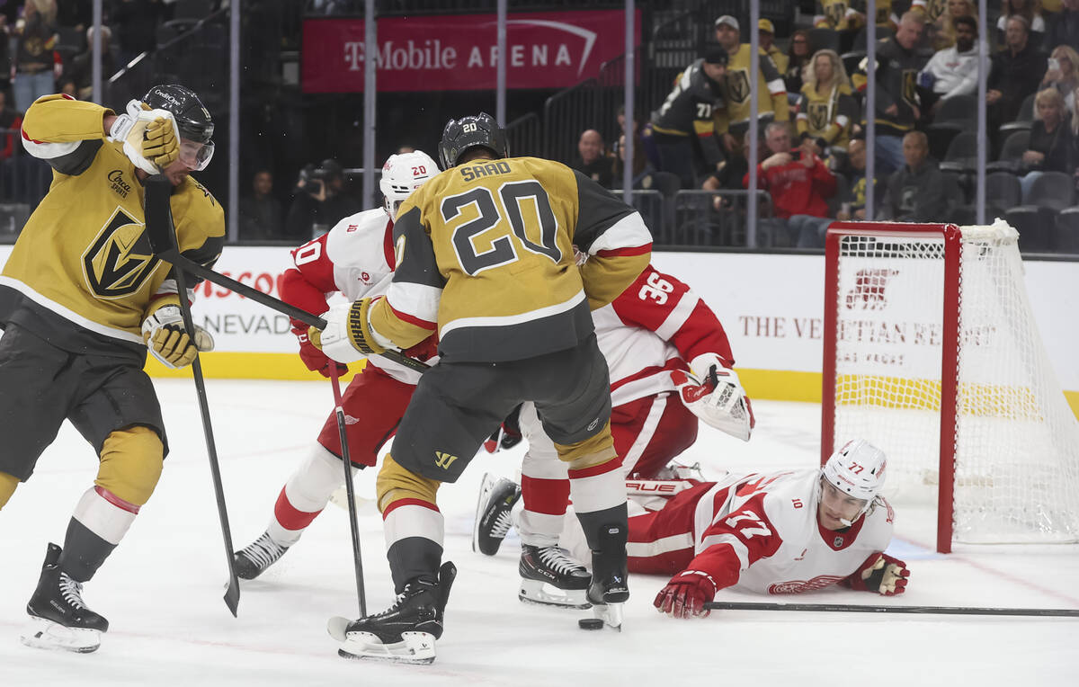 Detroit Red Wings defenseman Simon Edvinsson (77) slides to the ice as Golden Knights left wing ...