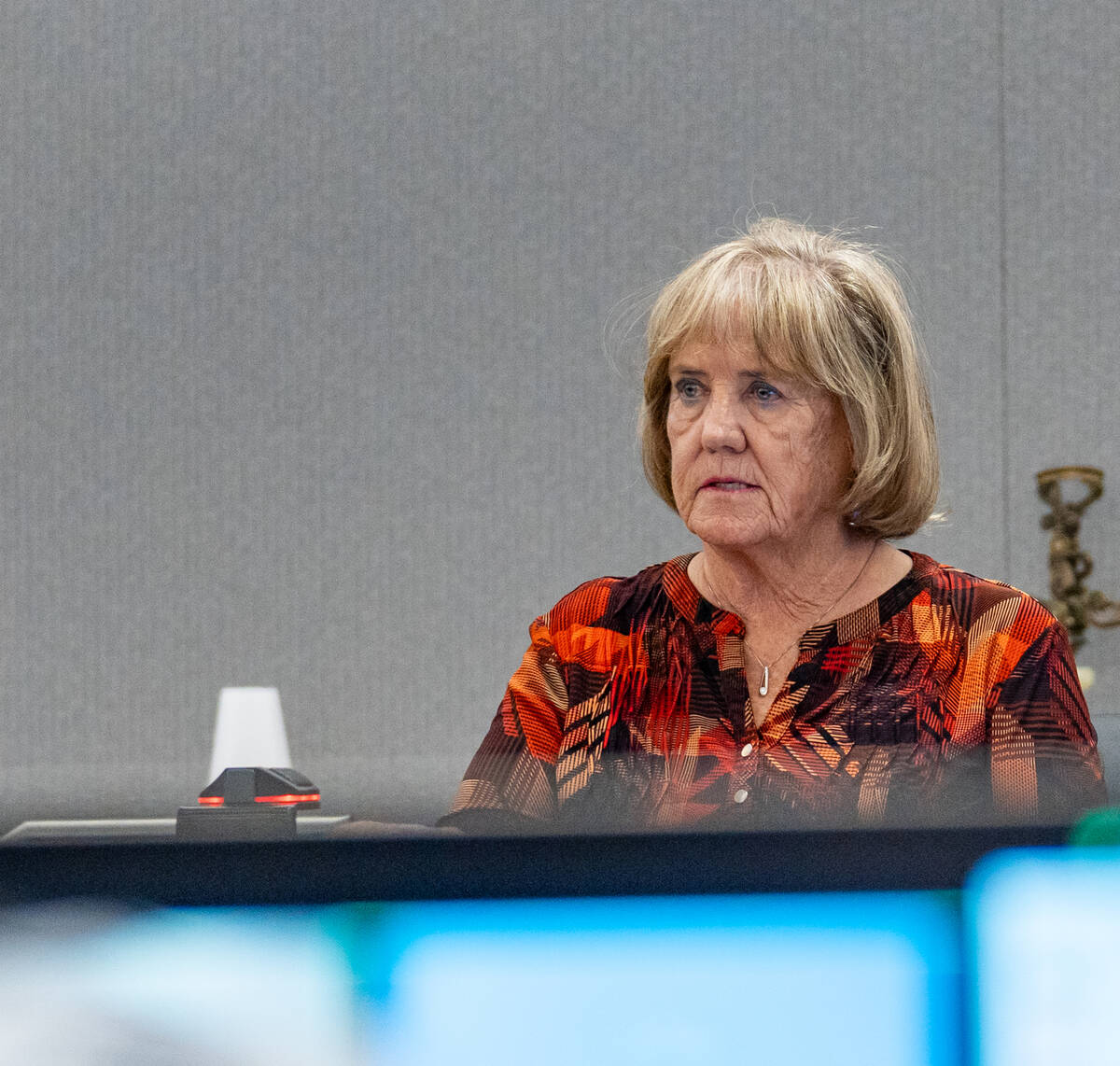 Mary Lou Walton, wife of local dentist George Monahan, who was killed in 1980, speaks to the co ...