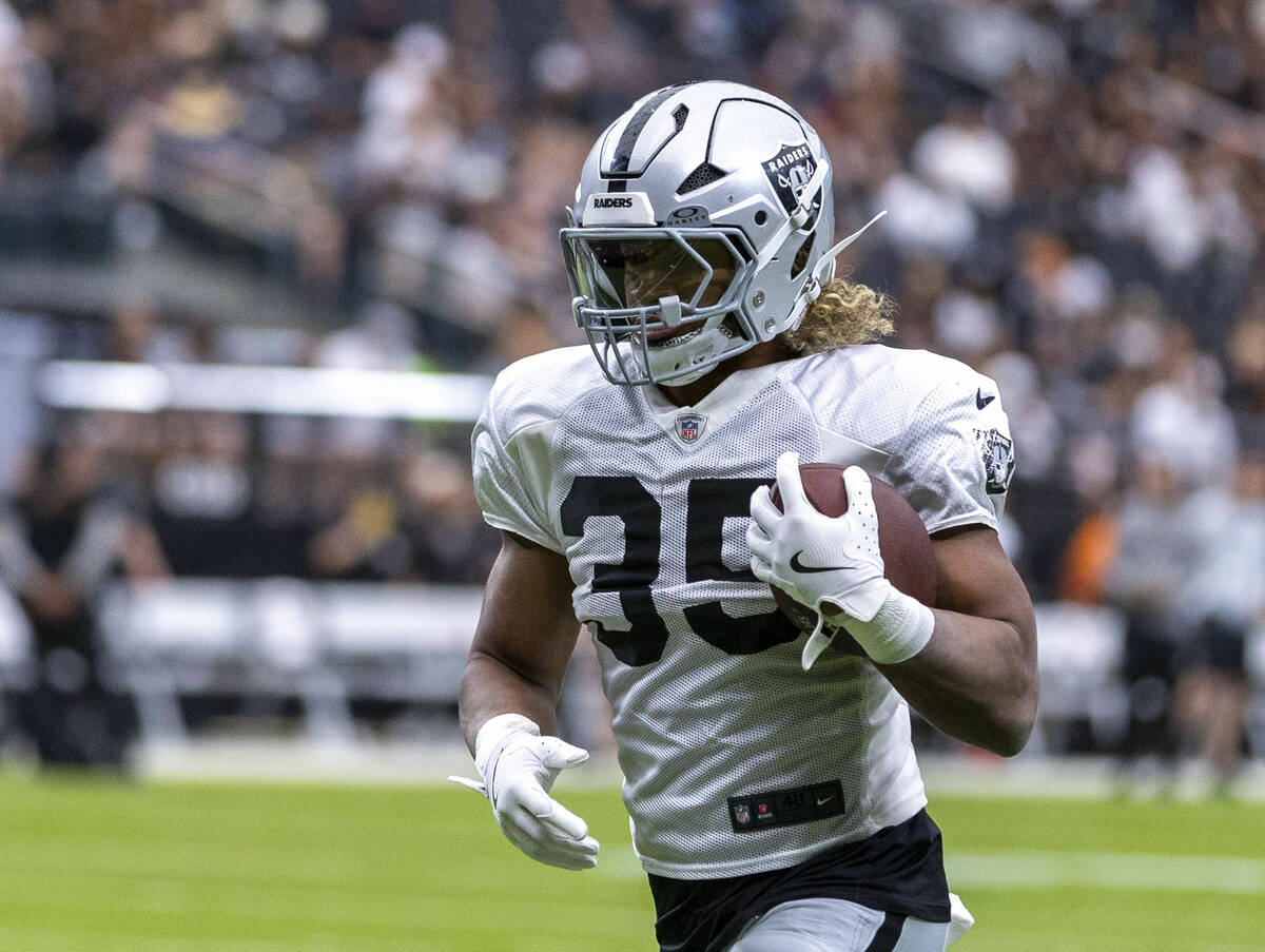Raiders running back Chris Collier (35) runs with the ball during the first half of a Raiders t ...