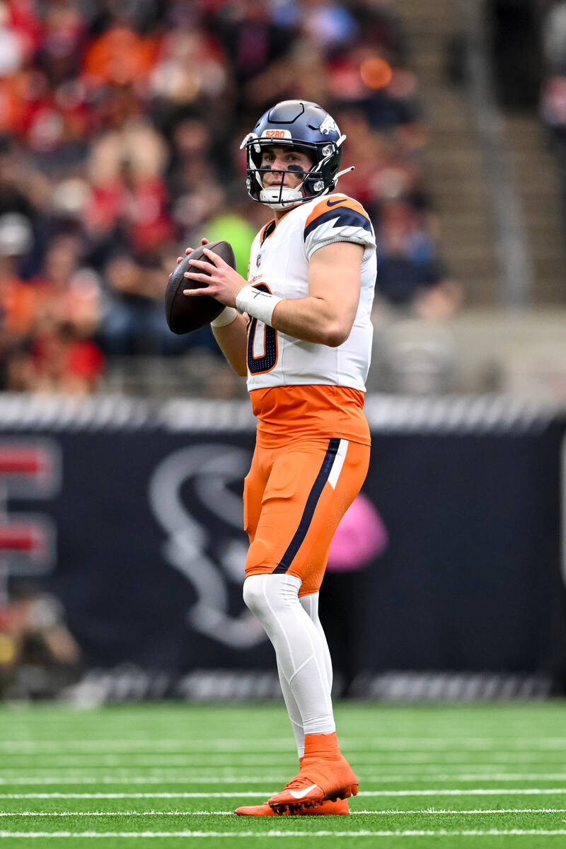 Denver Broncos quarterback Bo Nix (10) warms up on the field prior to the second quarter agains ...