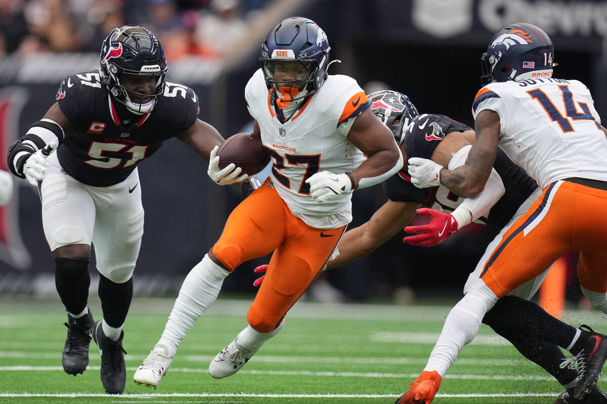 Denver Broncos running back J.K. Dobbins (27) runs against the Houston Texans during an NFL foo ...