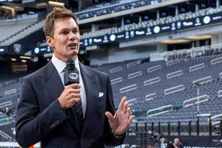 Raiders minority owner and Fox football analyst Tom Brady talks at Allegiant Stadium on Monday, ...