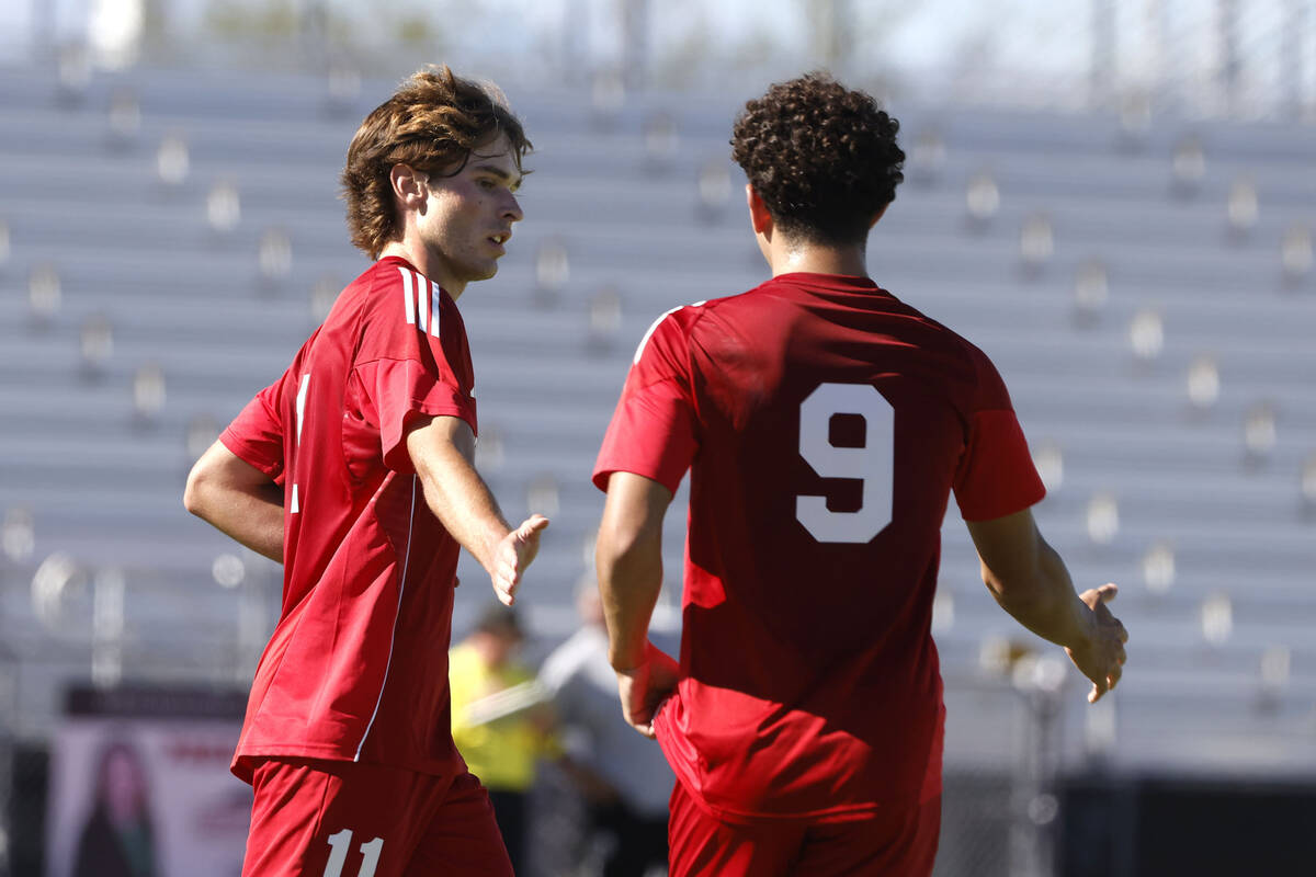Coronado striker Gavin Flickinger (11) celebrates his goal with midfielder Dylan Flores (9) dur ...