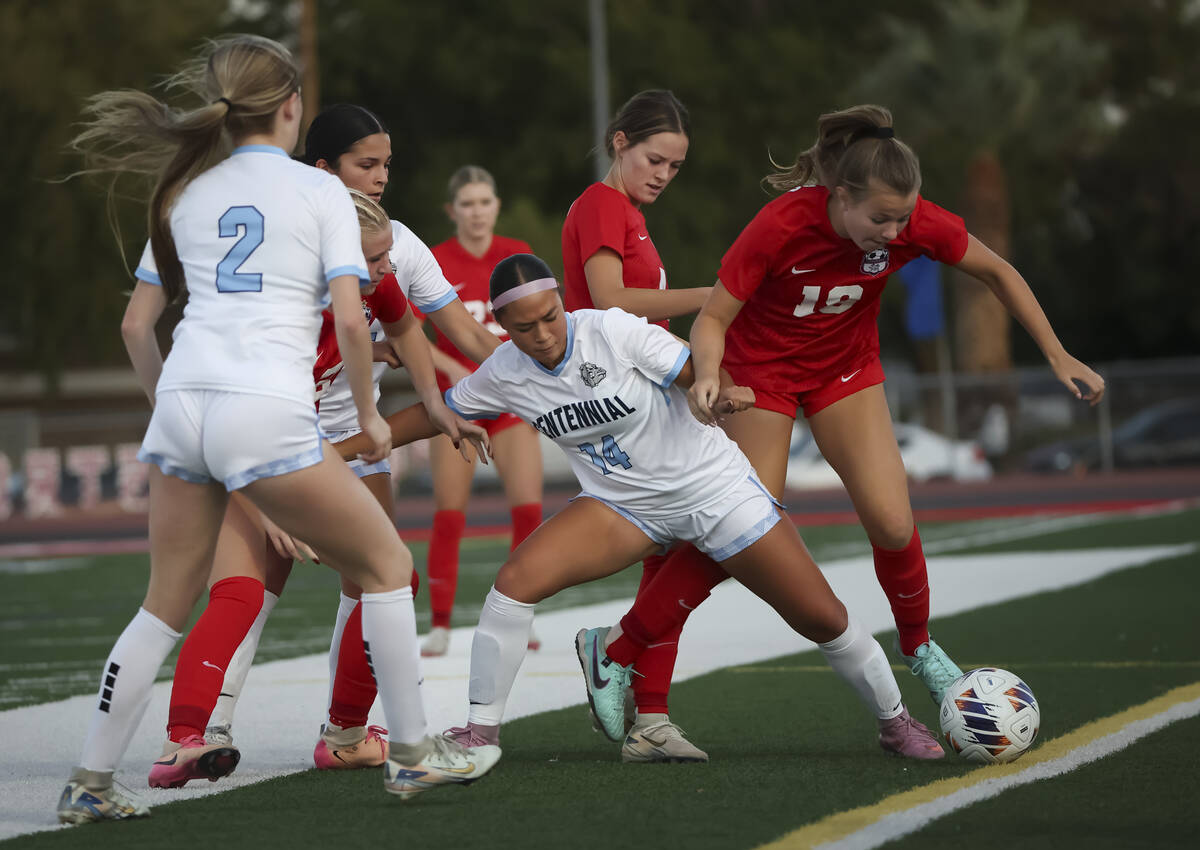 Centennial's Jordyn Base (14) and Coronado's Payton Jones (18) vie for the ball durin ...