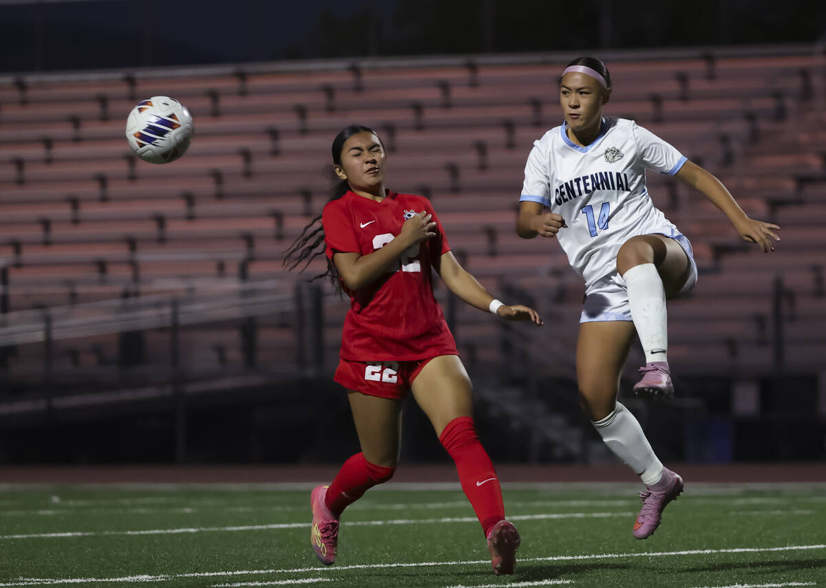 Centennial's Jordyn Base (14) kicks the ball in front of Coronado's Taylor Takahashi ...