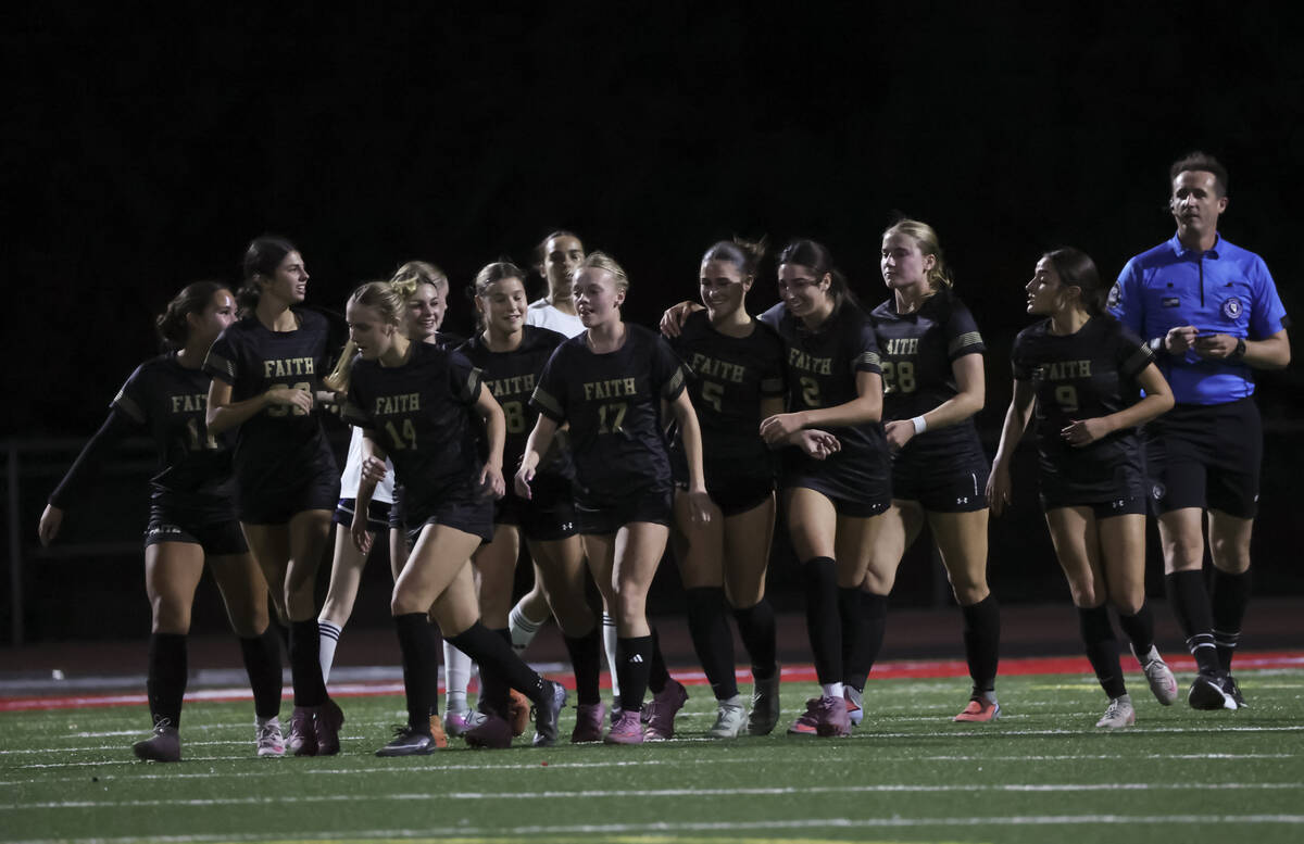 Faith Lutheran players celebrate after scoring against Shadow Ridge during the first half of a ...