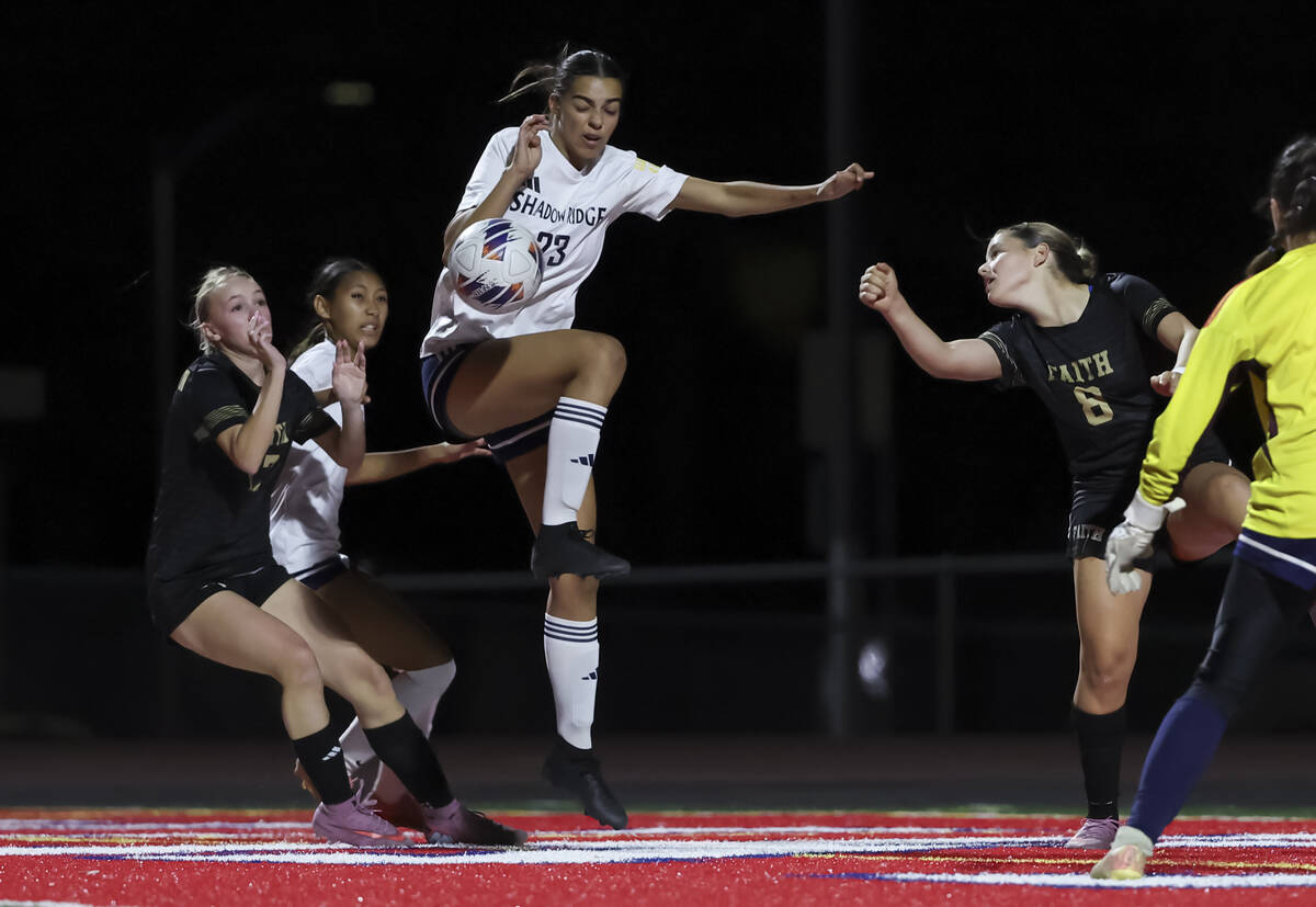 Shadow Ridge's Myla Hood (23) deflects the ball in front of Faith Lutheran's Posie Ar ...