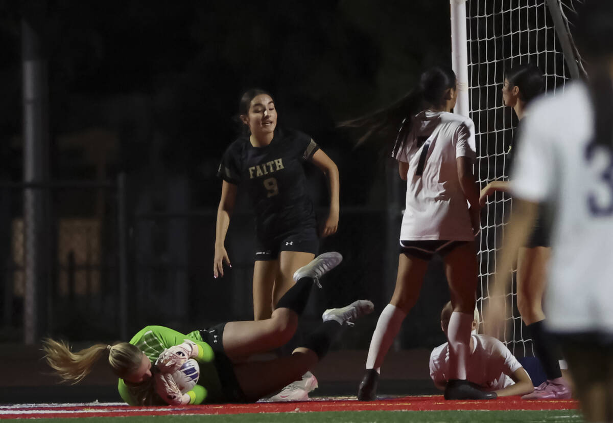 Faith Lutheran goalkeeper Olivia Petty (99) blocks a shot from Shadow Ridge during the second h ...