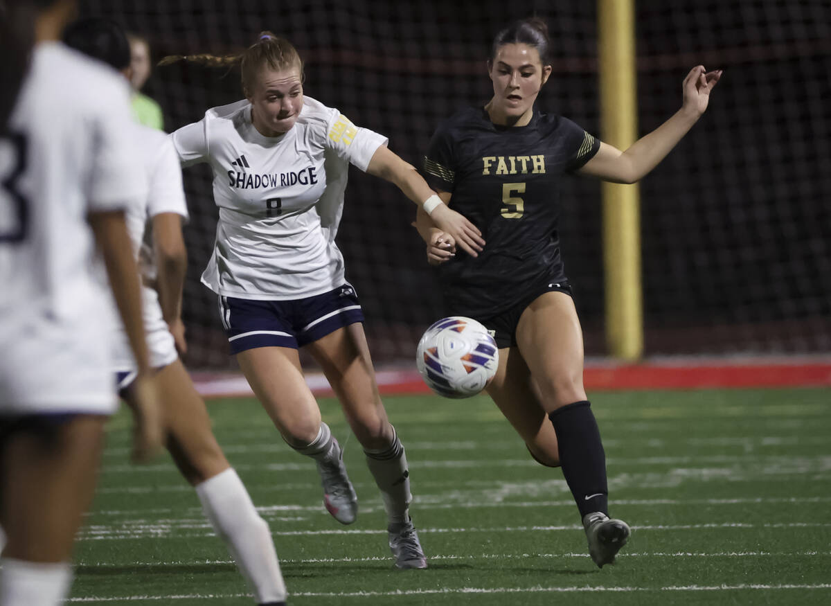 Faith Lutheran's Posie Armstrong (5) and Shadow Ridge's Harmony Taylor (8) vie for th ...