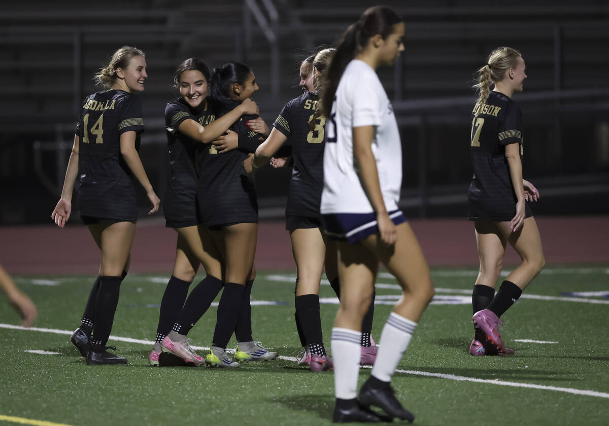 Faith Lutheran players celebrate after scoring against Shadow Ridge during the second half of a ...
