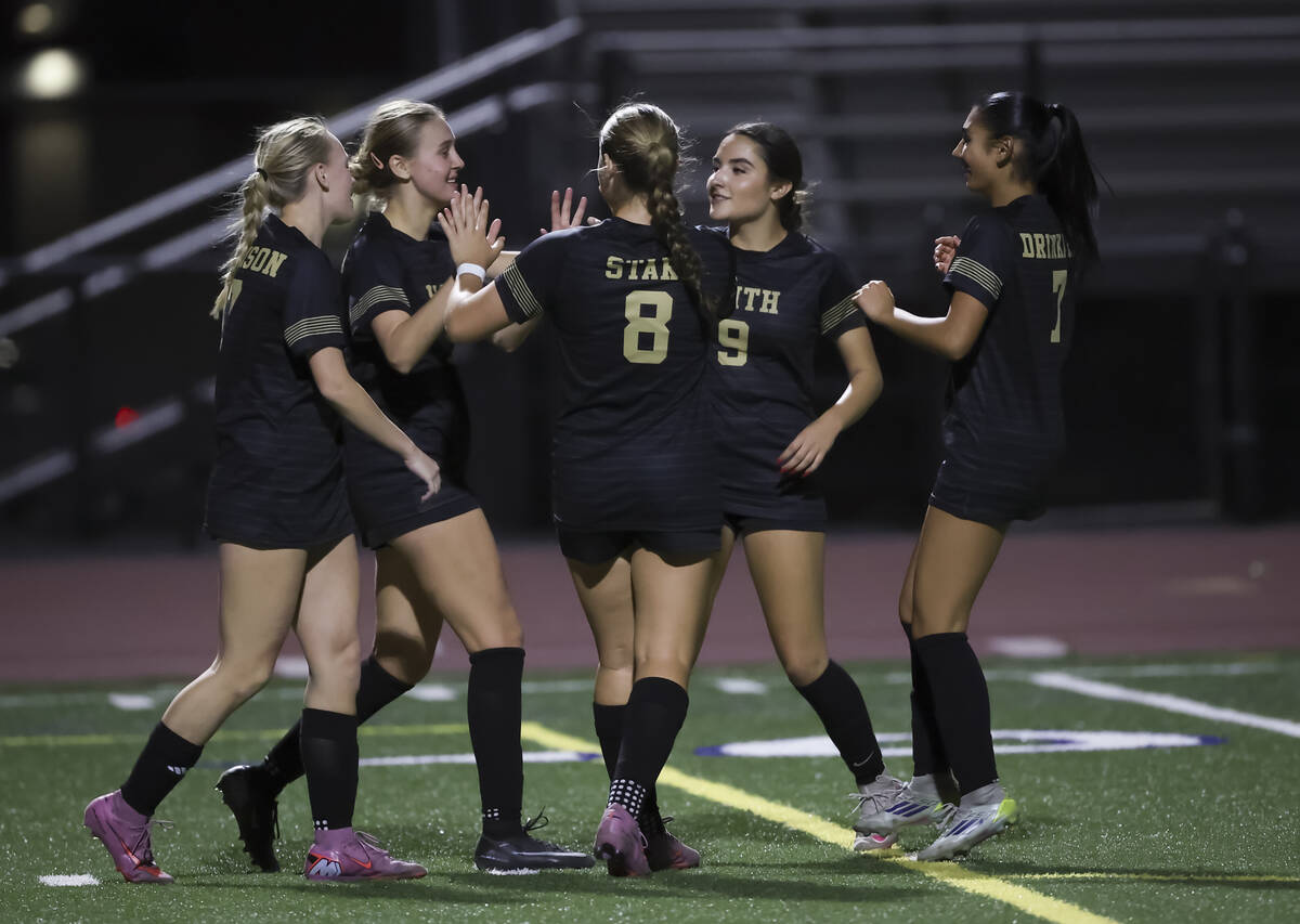 Faith Lutheran players celebrate after a goal against Shadow Ridge during the second half of a ...