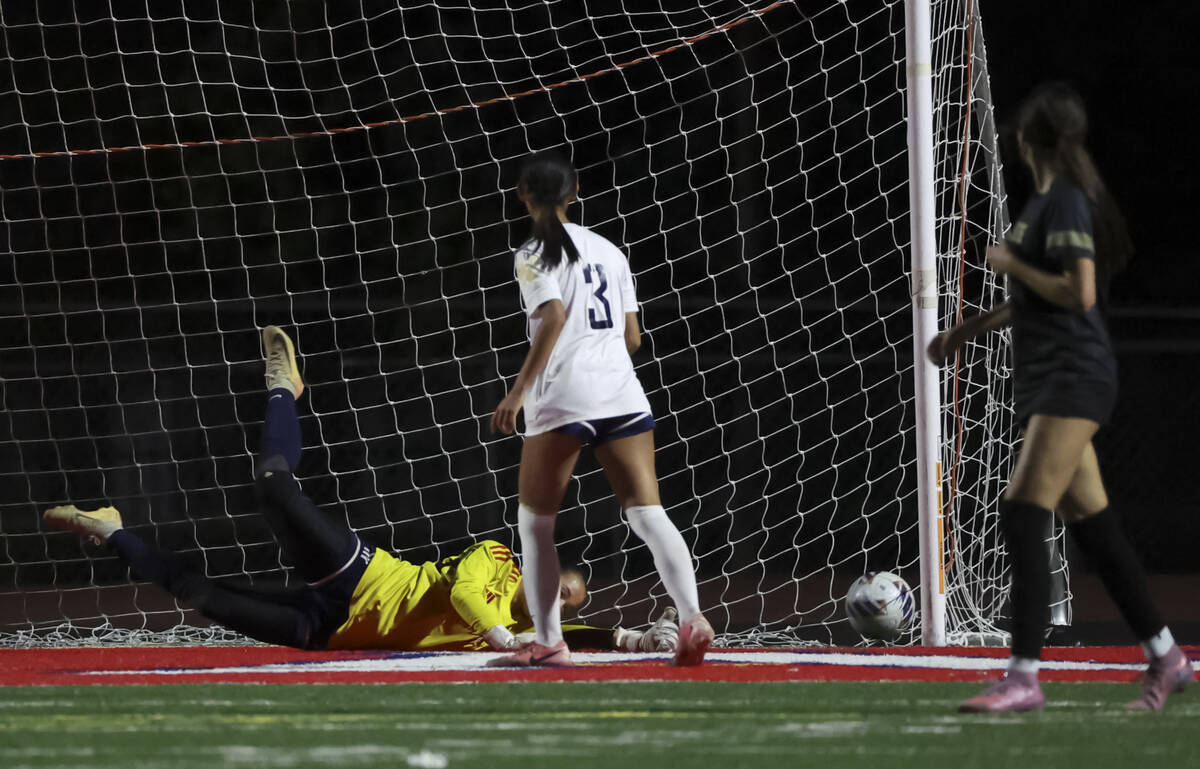 Faith Lutheran scores past Shadow Ridge goalkeeper Keira Torres during the first half of a Clas ...