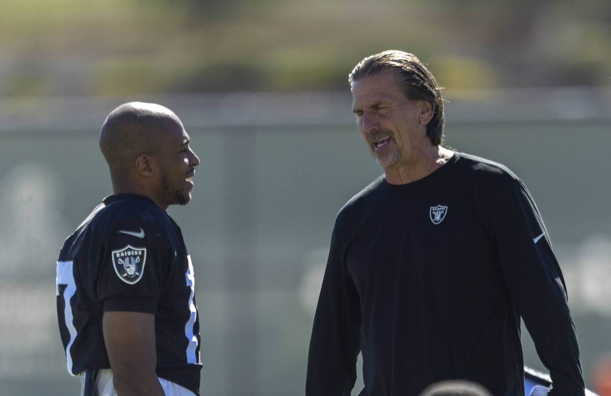 Raiders wide receiver Tyler Lockett, left, speaks with quarterbacks coach Greg Olson during the ...