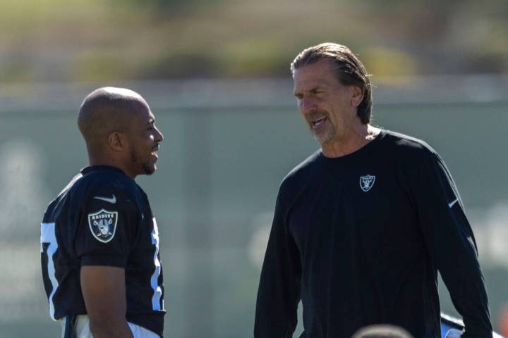 Raiders wide receiver Tyler Lockett, left, speaks with quarterbacks coach Greg Olson during the ...