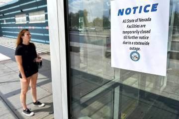 A woman arrives at the DMV office on east Sahara Avenue to find it closed due to a massive stat ...