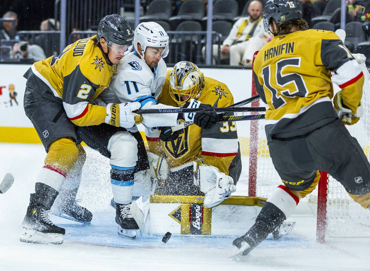 Golden Knights goaltender Adin Hill (33) deflects a shot by Utah Mammoth right wing Dylan Guent ...