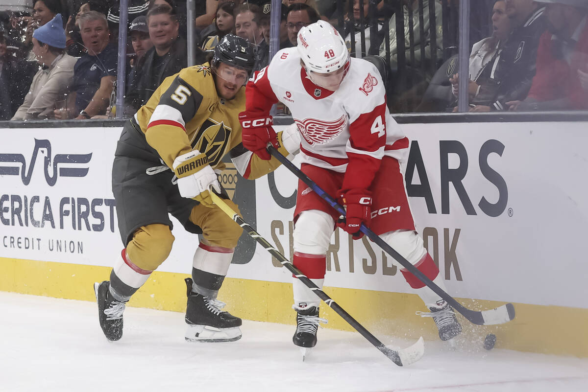 Detroit Red Wings right wing Jonatan Berggren (48) and Golden Knights defenseman Jeremy Lauzon ...