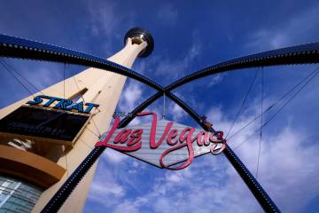 The STRAT hotel-casino is seen next to City of Las Vegas sign, on Friday, Jan. 19, 2024, in Las ...