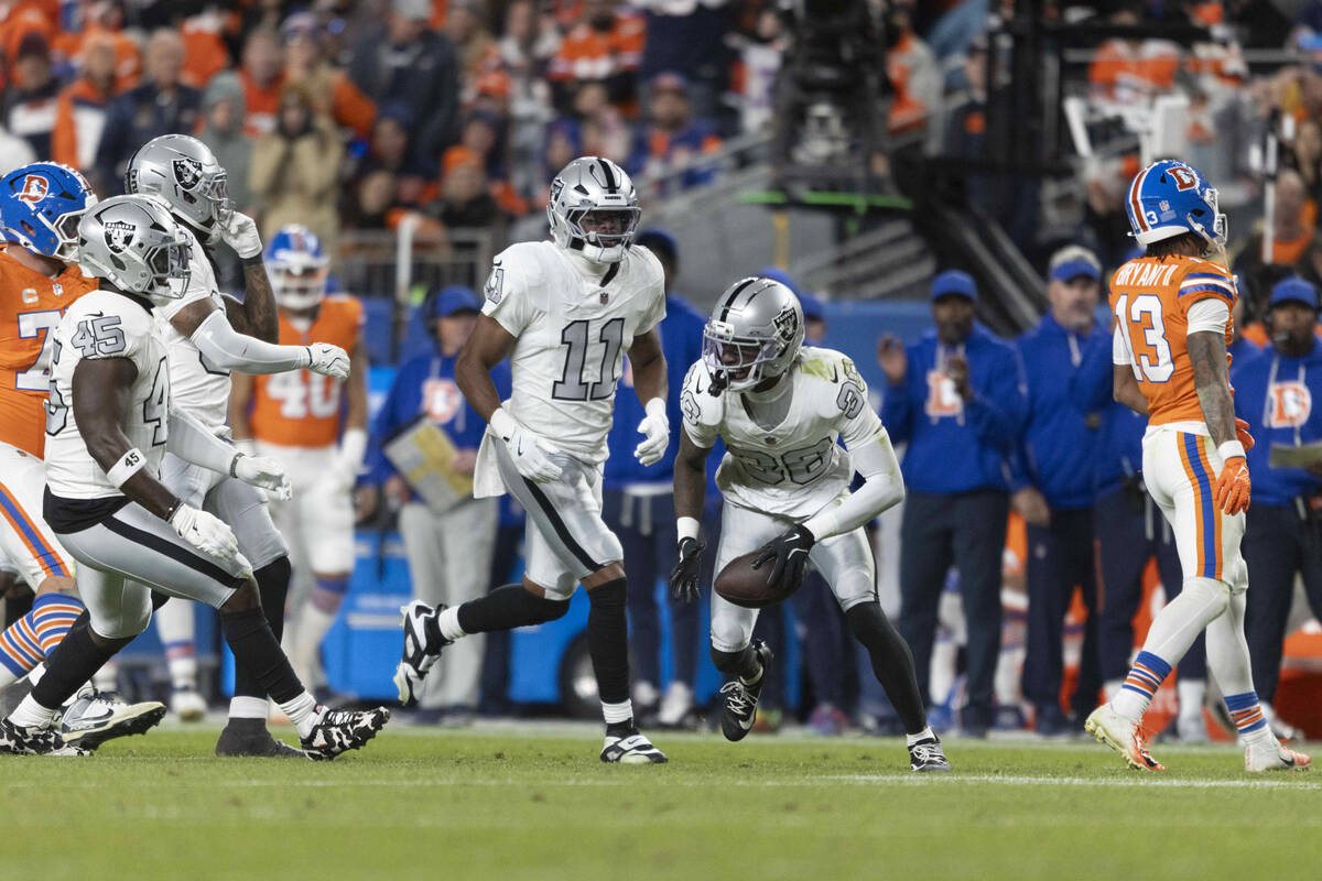 Raiders cornerback Kyu Blu Kelly (36) celebrates his interception with safety Jeremy Chinn (11) ...
