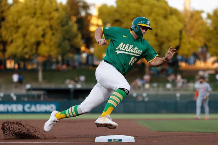 FILE - Athletics' Nick Kurtz rounds third base before scoring during the first inning of a base ...