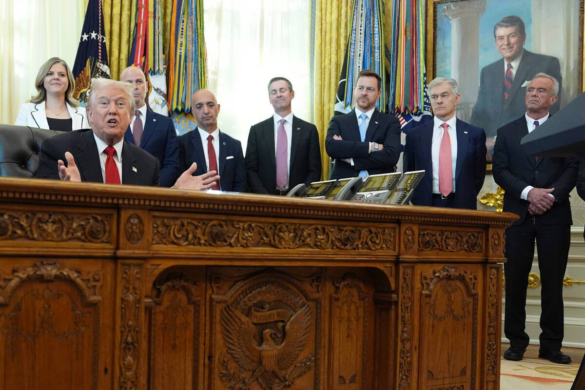 President Donald Trump speaks as Heidi Overton, deputy director of the White House Domestic Pol ...