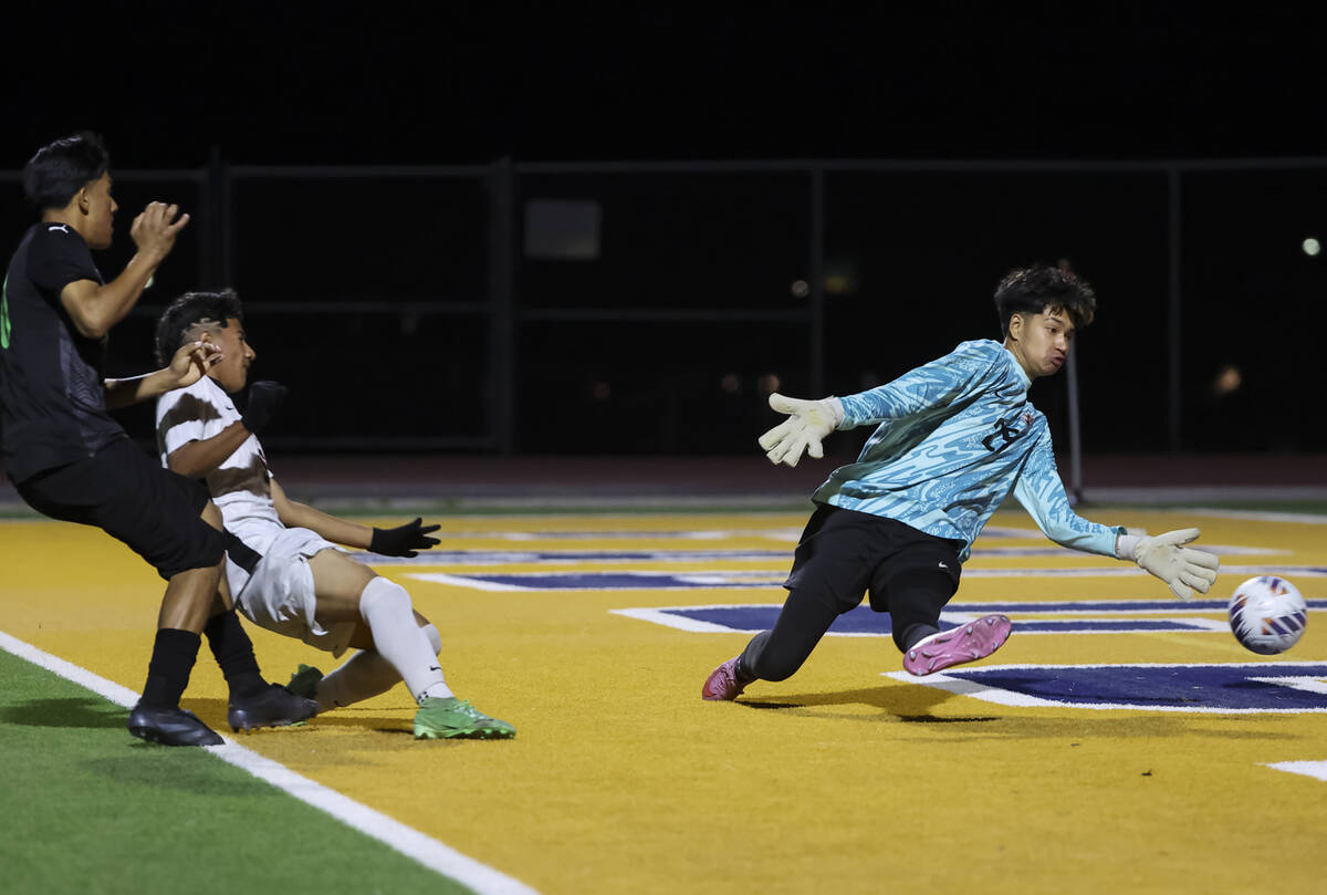 SLAM! Nevada's Manny Mendez, left, kicks the ball in past Chaparral goalkeeper Jozabad Gar ...