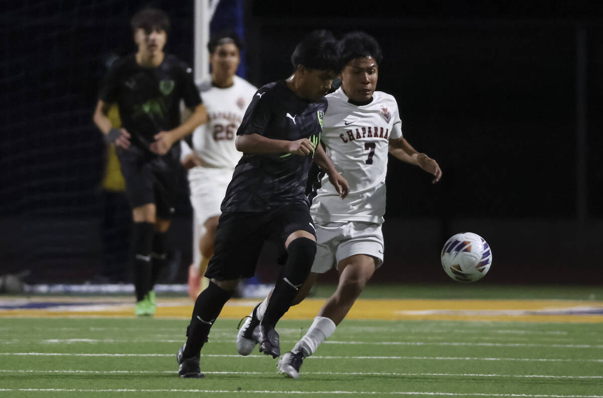 SLAM! Nevada's Caleb Garcia (15) and Chaparral's Javier Marenco (7) battle for the ba ...