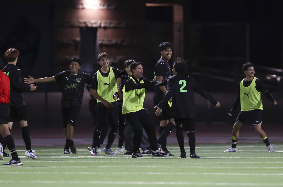 SLAM! Nevada players celebrate after defeating Chaparral to win a Class 4A boys soccer state se ...