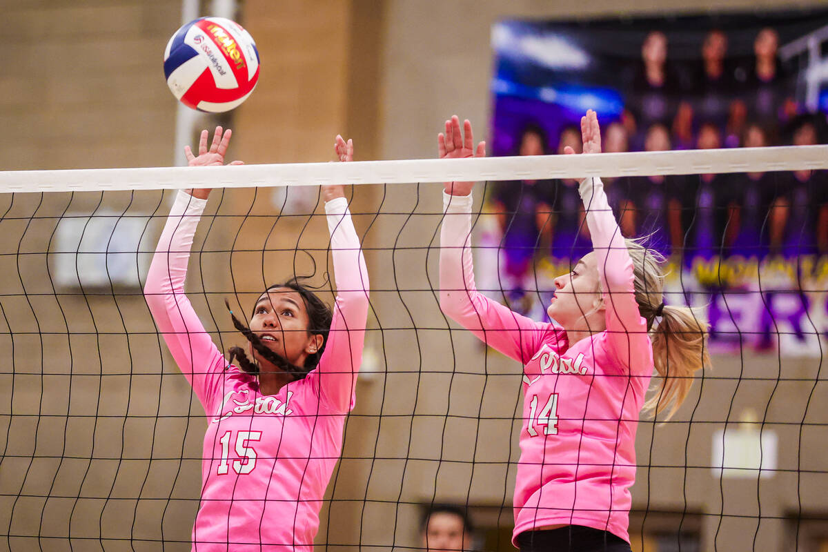 Coral middle blocker Liana Sigel (15) sends the ball back over the net during a class 4A girls ...