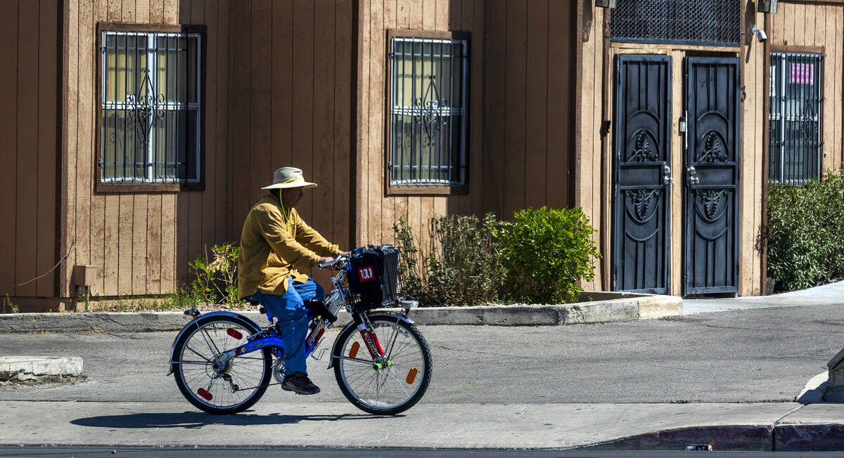 A cyclist keeps cool under a hat as he pedals along East Charleston Boulevard as the city has o ...