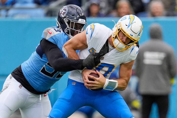 Los Angeles Chargers quarterback Justin Herbert (10) is sacked by Tennessee Titans linebacker J ...