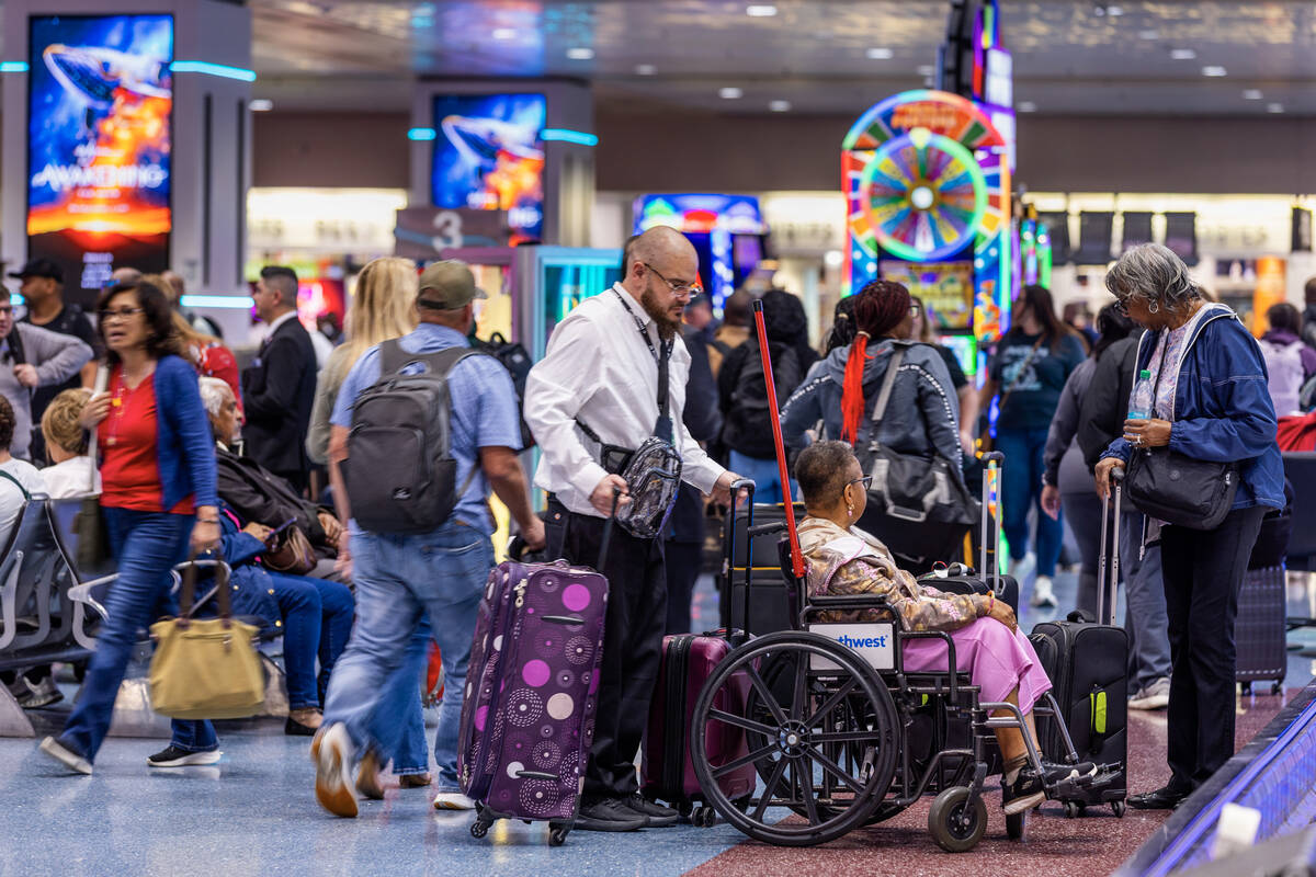 Passengers gather their baggage as the FAA has reduced flights by 4% so far at Harry Reid Inter ...