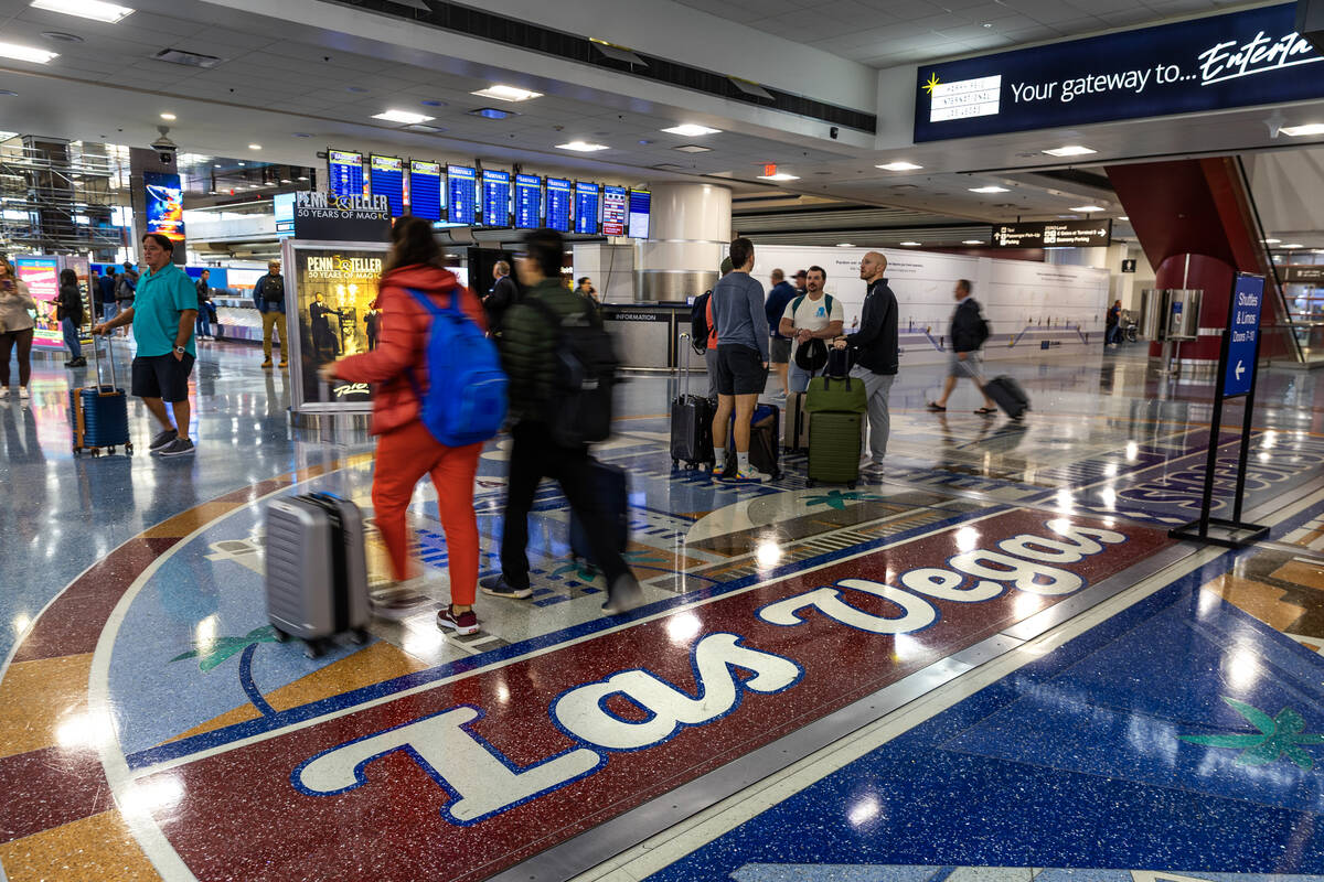 Passengers depart with their baggage as the FAA has reduced flights by 4% so far at Harry Reid ...