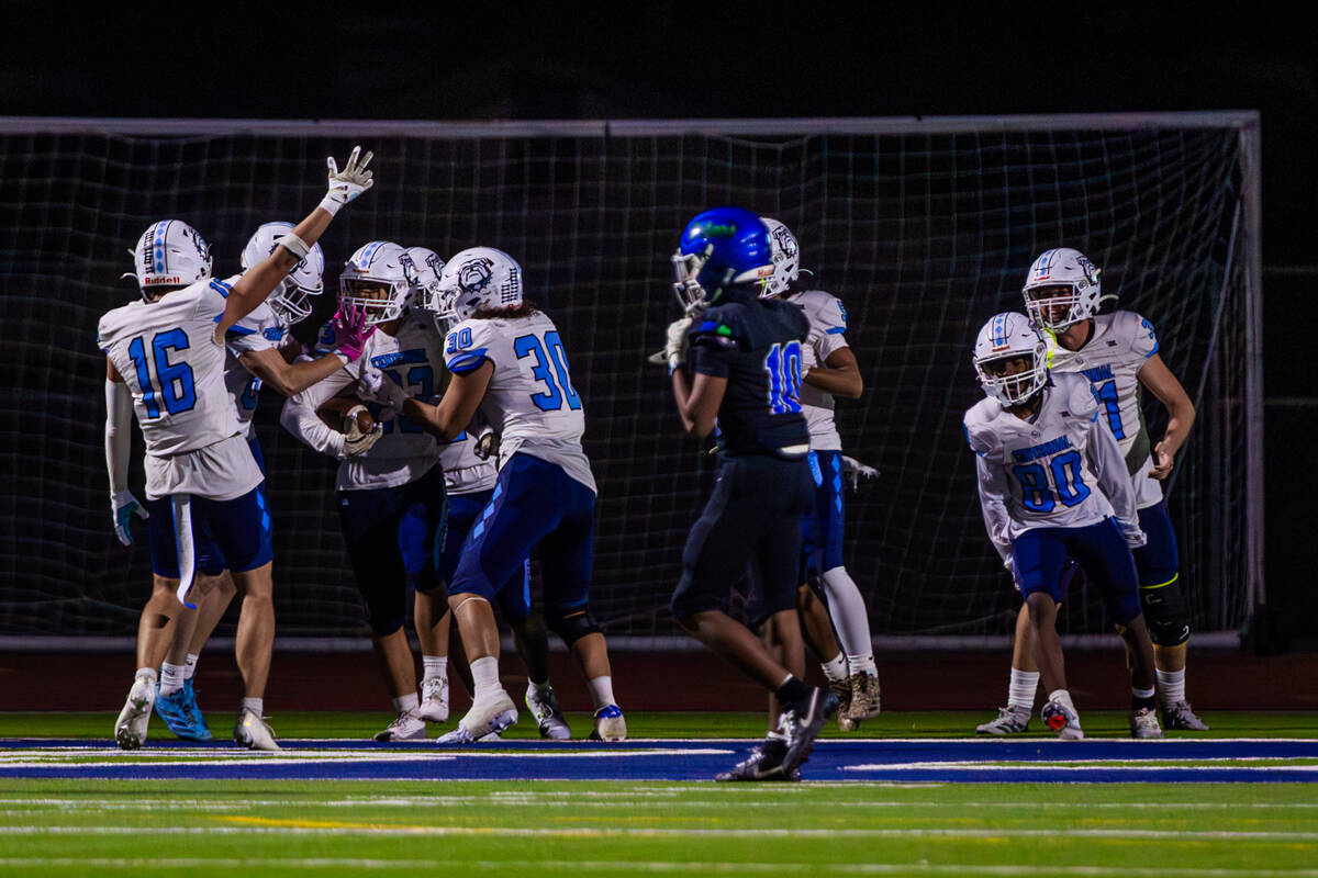 Centennial players celebrate a touchdown during a class 5A high school football southern region ...