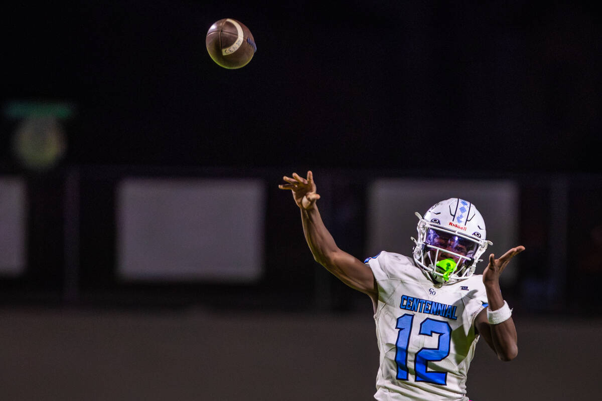 Centennial quarterback Nehemiah Dunlap-Myvett throws the ball during a class 5A high school foo ...