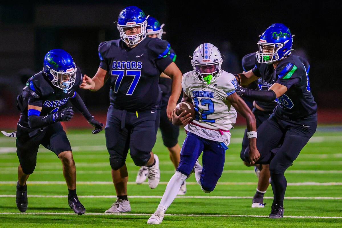 Centennial quarterback Nehemiah Dunlap-Myvett scrambles with the ball during a class 5A high sc ...