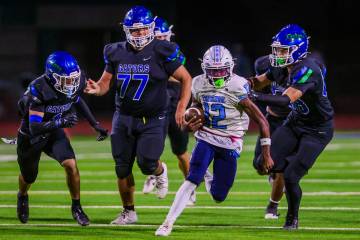 Centennial quarterback Nehemiah Dunlap-Myvett scrambles with the ball during a class 5A high sc ...