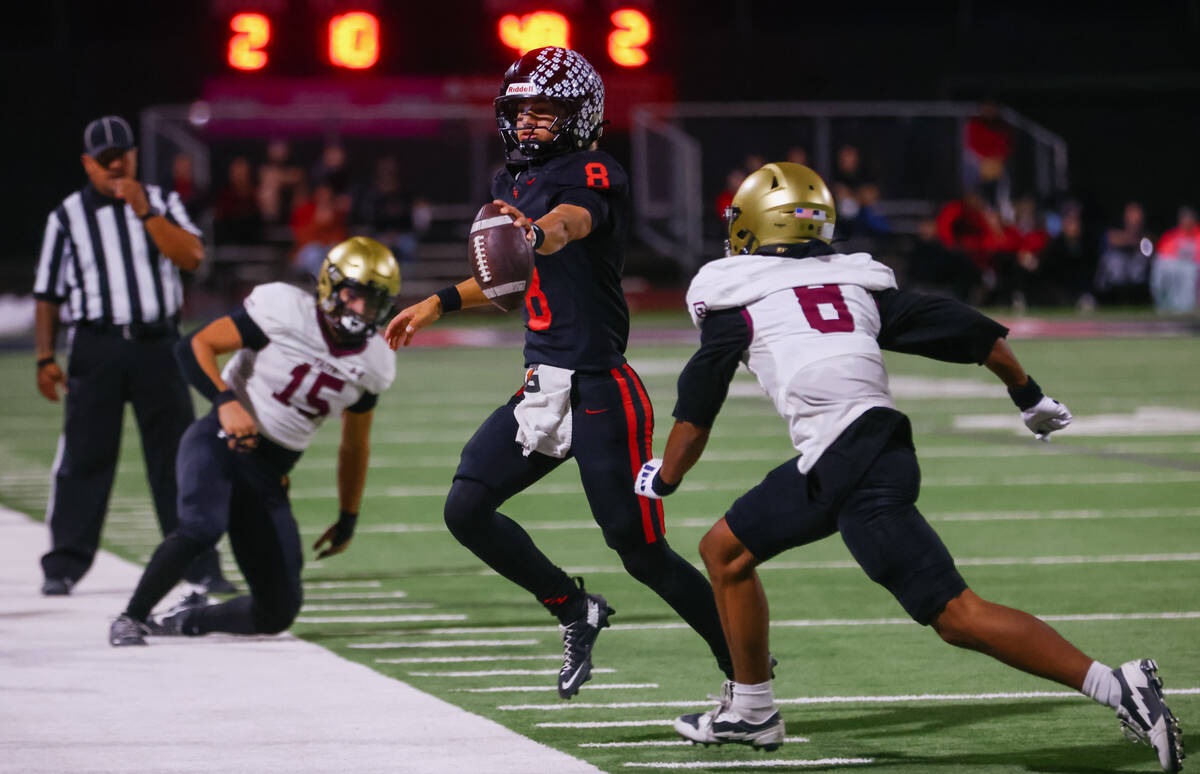 Las Vegas quarterback Tanner Vibabul (8) reaches for more yardage as he is run out of bounds by ...