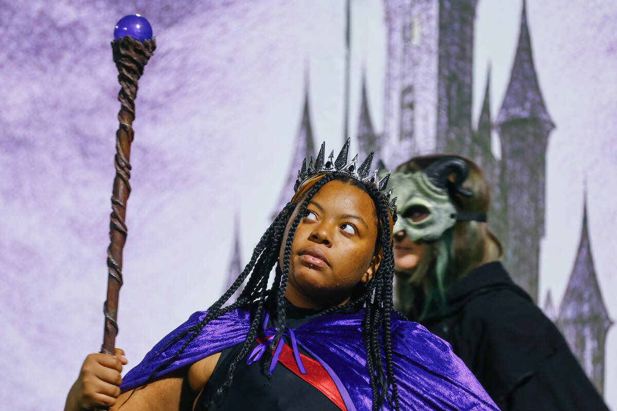 Members of the color guard dance through a fantasy-inspired routine as the Las Vegas High Schoo ...