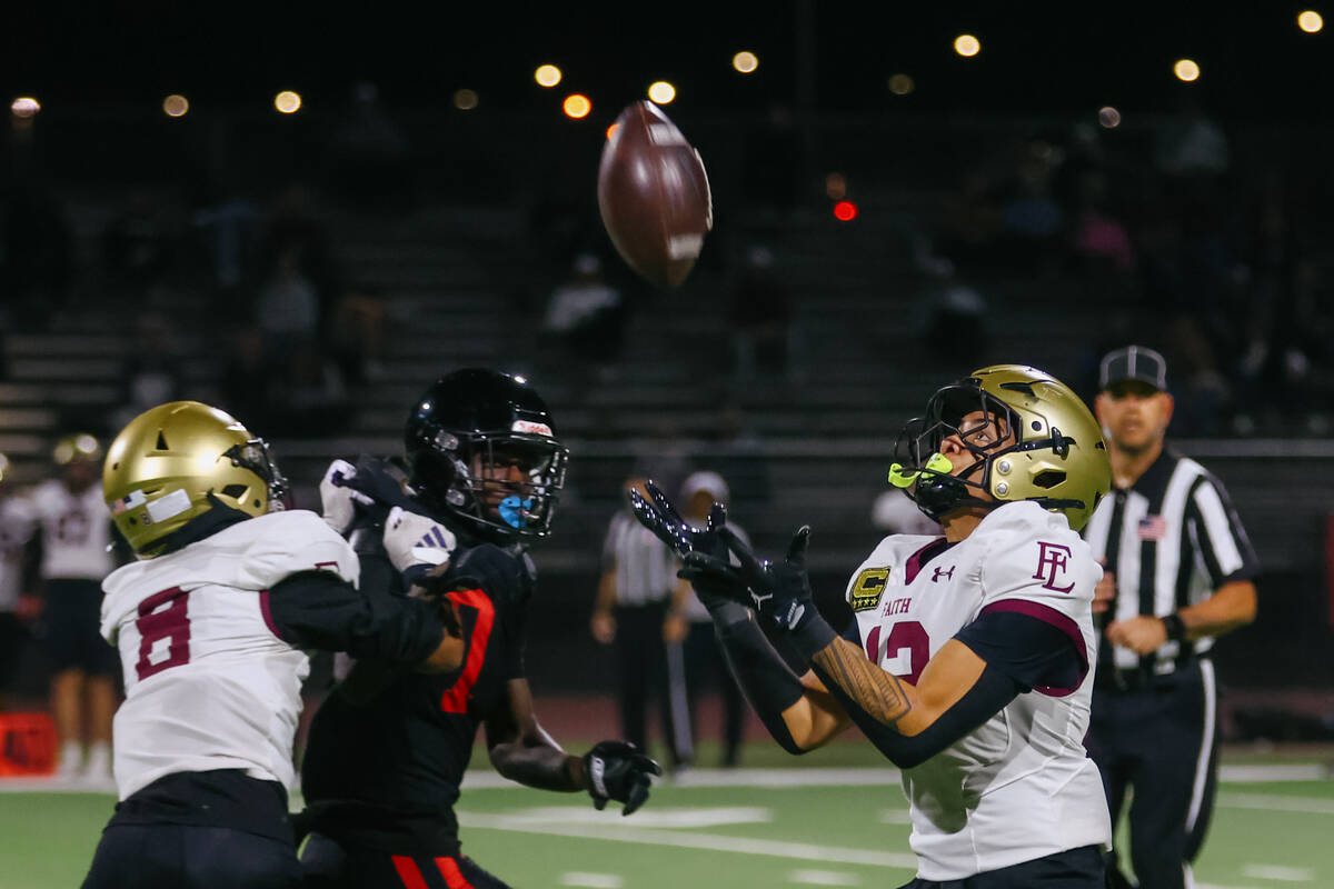 Faith Lutheran wide receiver Aipa Kuloloia (12) makes a fair catch during the Southern Region s ...