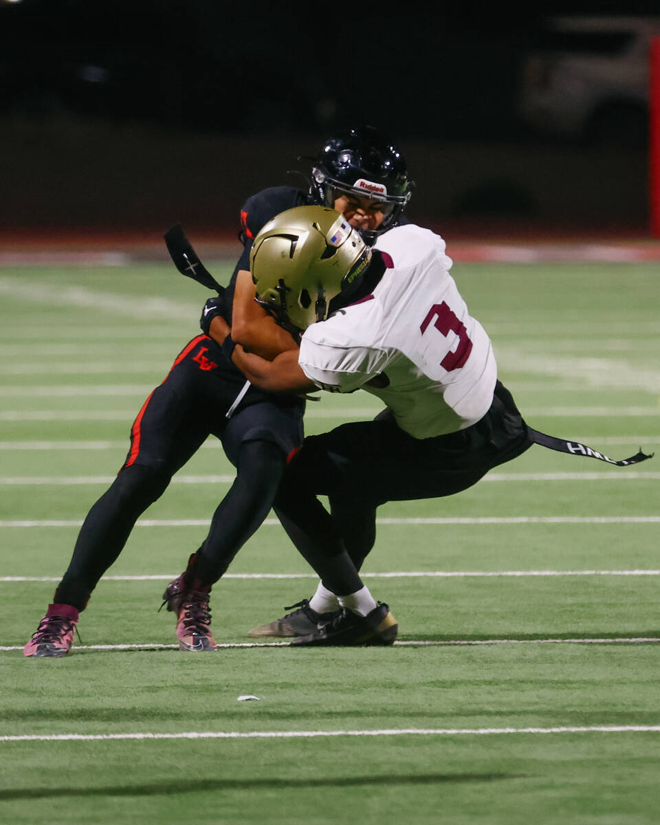 Faith Lutheran defensive back Treylon Fox (3) tackles Las Vegas wide receiver Rian Jaime (81) d ...
