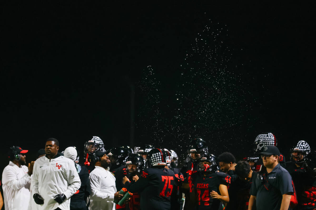 The Las Vegas sideline sprays water into the air to hype up the team after the Wildcats regaine ...
