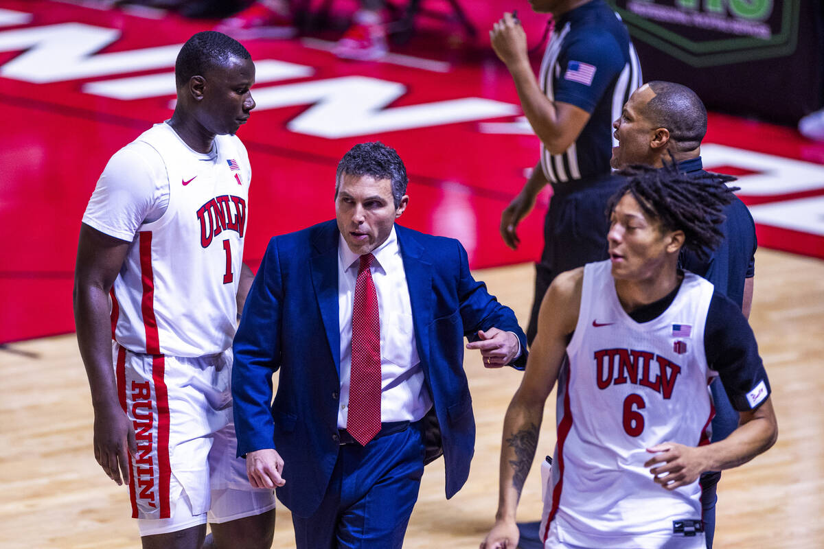 UNLV head coach Josh Pastner talks with forward Tyrin Jones (6) as he enters the game against t ...