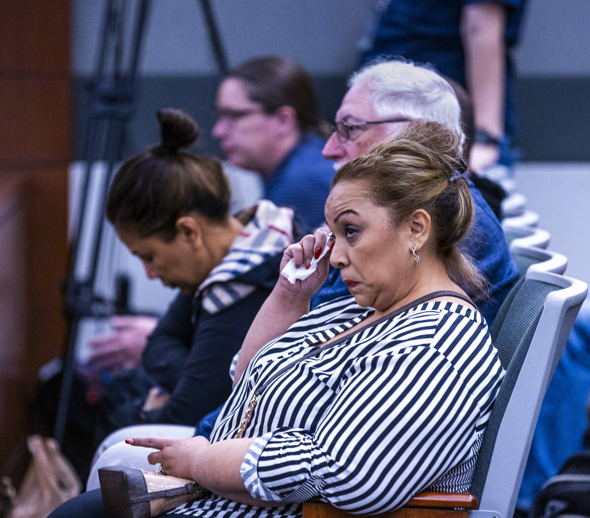 Family members look on as autopsy photos are examined during the murder trial for Devyn Michael ...
