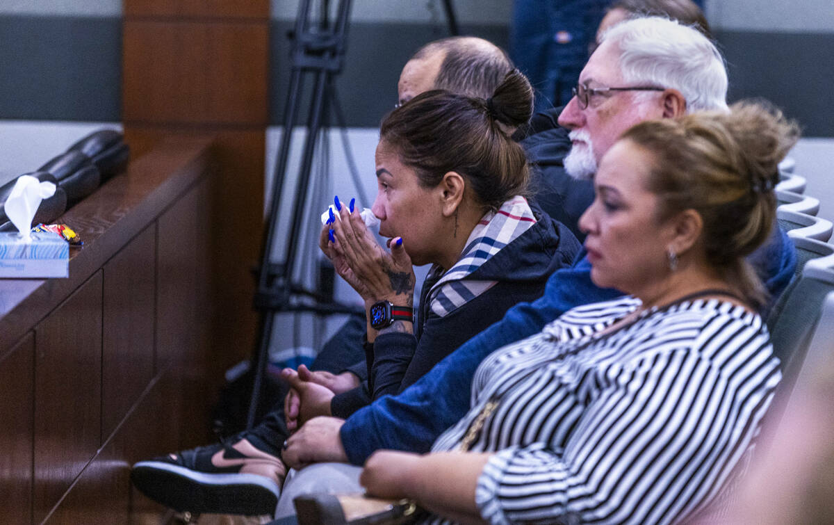 Family members look on as autopsy photos are examined during the murder trial for Devyn Michael ...