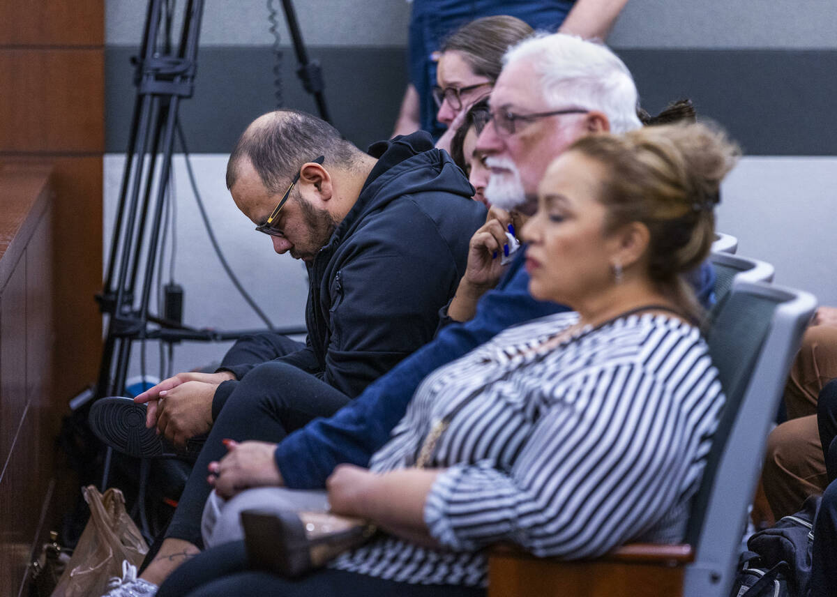 Family members look on as autopsy photos are examined during the murder trial for Devyn Michael ...