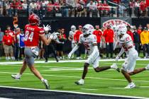 UNLV tight end Nick Elksnis (84) looks back for a touchdown pass as New Mexico Lobos cornerback ...