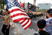 People watch the annual Veterans Day Parade in downtown Las Vegas on Tuesday, Nov. 11, 2025, in ...