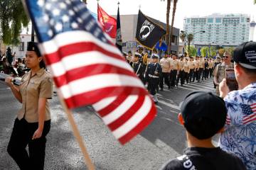 People watch the annual Veterans Day Parade in downtown Las Vegas on Tuesday, Nov. 11, 2025, in ...